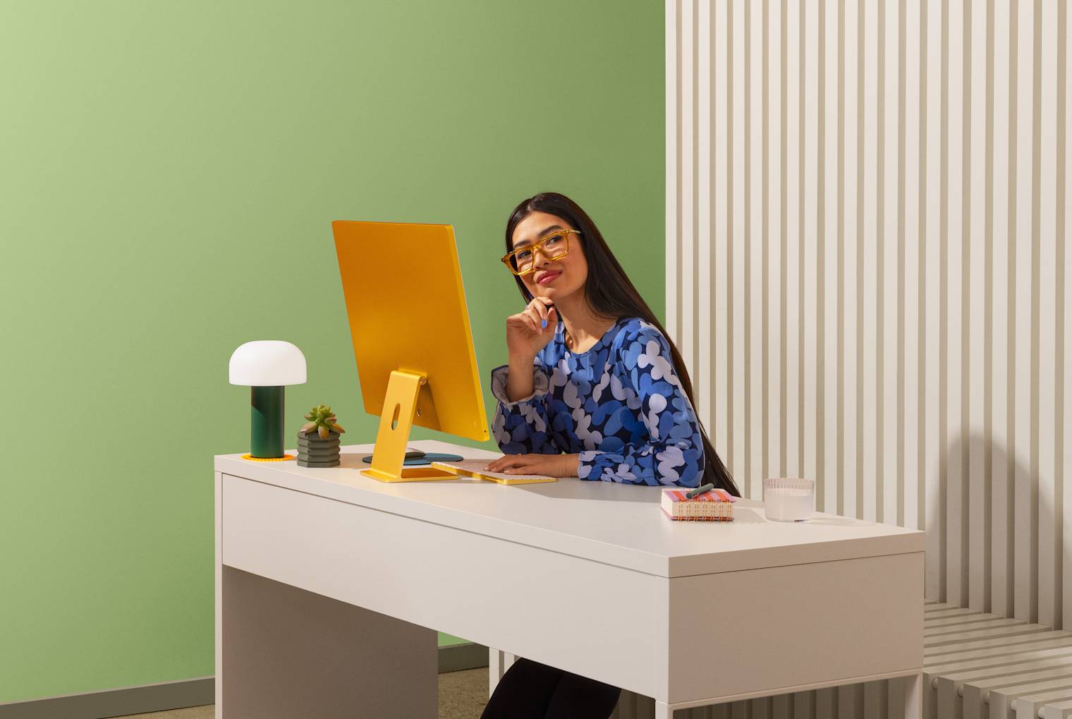Person at a desk with a desktop computer