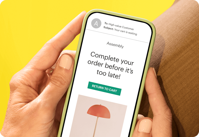 Image depicting a person holding a smartphone displaying an email from the fictitious brand Assembly. The visual demonstrates how businesses can use Mailchimp’s Customer Journey triggers to stay on top of their customer’s behavior and engage with them as soon as they show interest.